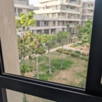 Garden and compound buildings view from the Villette apartment window - إطلالة على الحدائق ومباني الكمبوند من شباك شقة فيليت - Villette SODIC compound