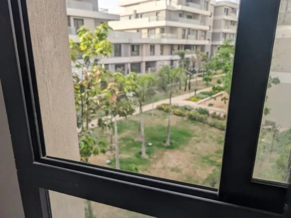 Garden and compound buildings view from the Villette apartment window - إطلالة على الحدائق ومباني الكمبوند من شباك شقة فيليت - Villette SODIC compound
