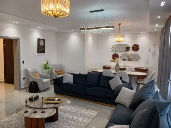 Elegant furnished living room with blue sofas in the SODIC Eastown apartment - ريسبشن مفروش بكنب أزرق في شقة سوديك إيستاون - furnished apartment for rent in Eastown New Cairo