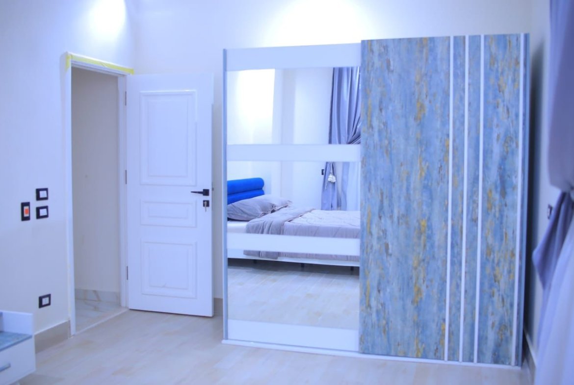 Bedroom door and a mirrored wardrobe with a blue marbled panel - apartment in El Yasmeen 1, New Cairo