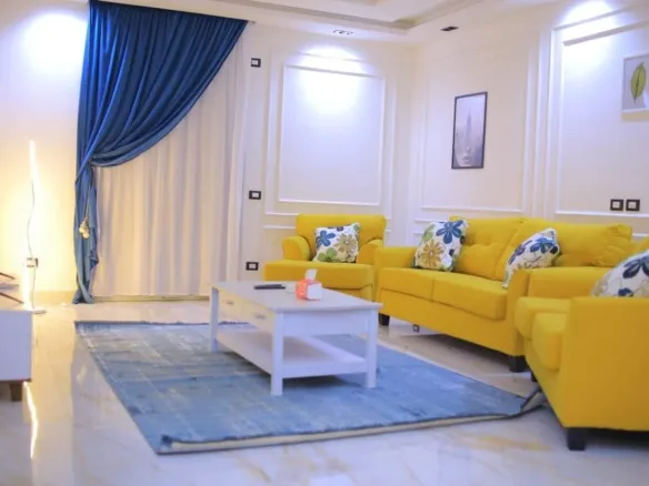 Living room with yellow sofa and blue curtains - معيشة بكنبة صفراء وستائر زرقاء - furnished apartment for rent El Yasmeen 1