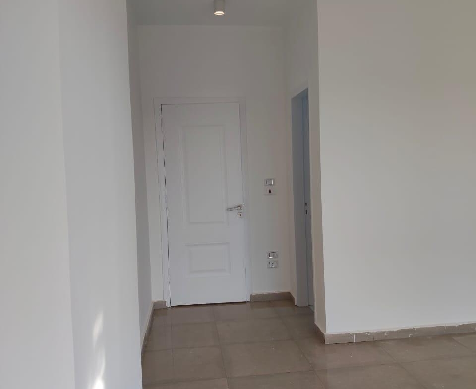Corridor with white doors and a tiled floor - apartment in Capital Gardens, New Cairo