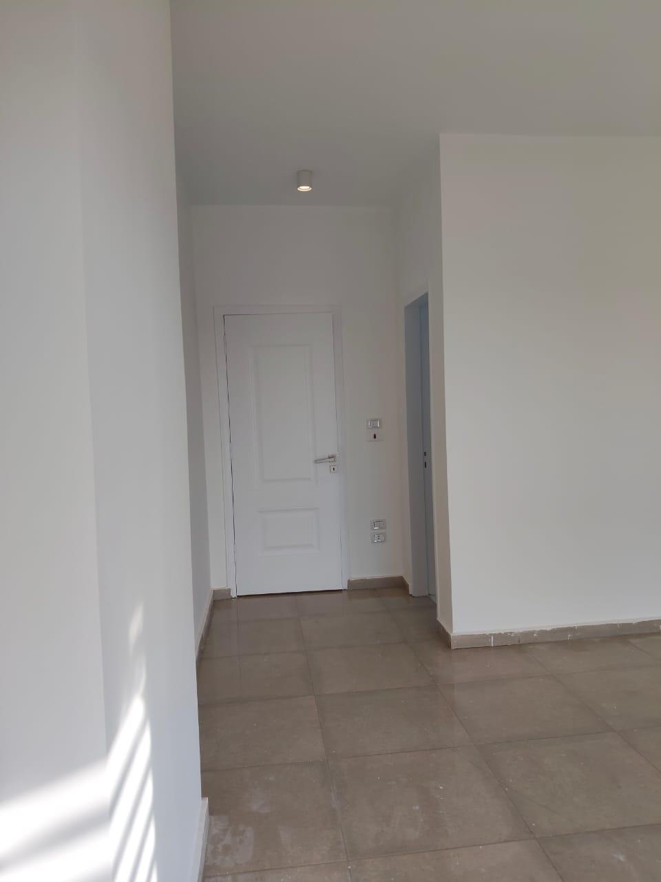 property-image-69ebfd2277265 Corridor with white doors and a tiled floor - apartment in Capital Gardens, New Cairo