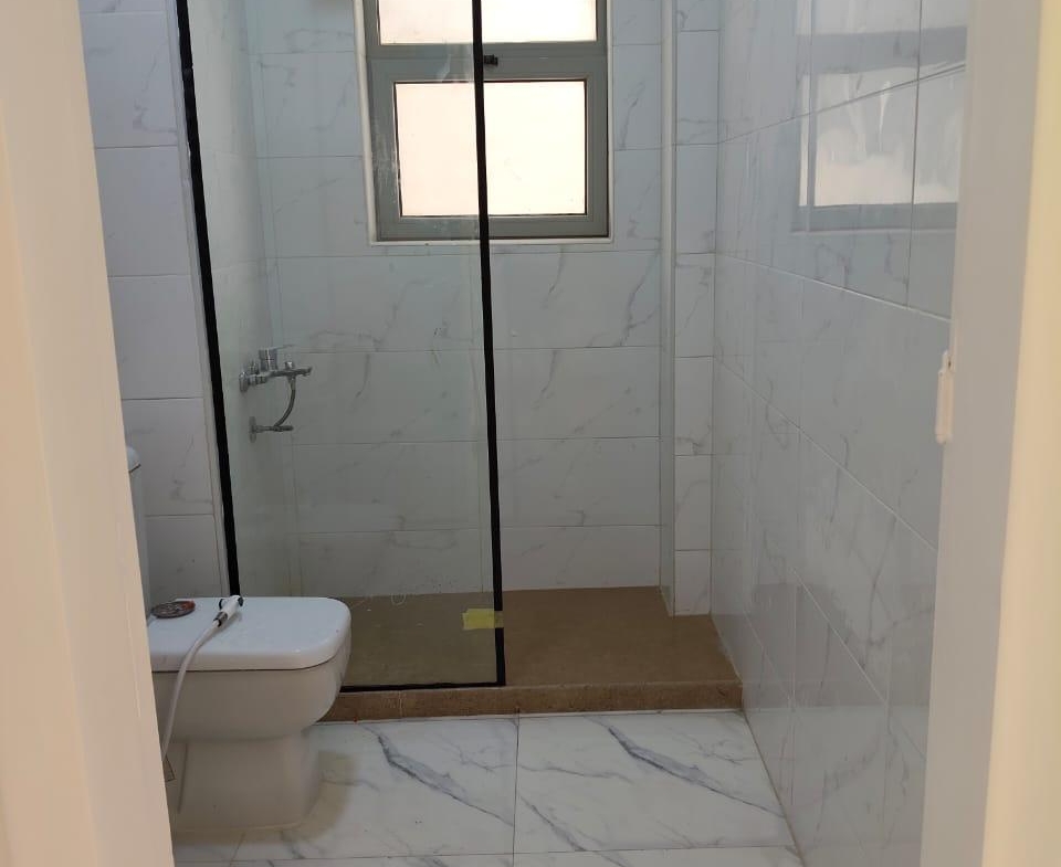 Bathroom with a black-framed glass shower and white marble tiles - apartment in Capital Gardens, New Cairo