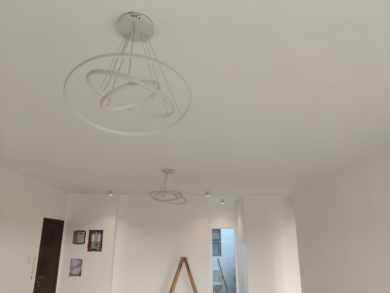 property-image-69ebfd26c5e22 Room with ring-shaped pendant lights and a doorway - apartment in Capital Gardens, New Cairo