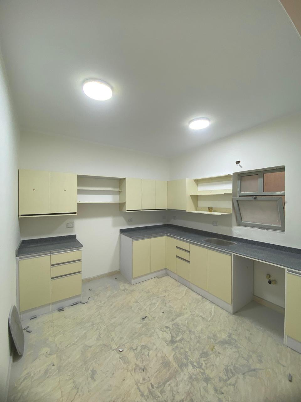property-image-69ebfd2a2818b Kitchen with cream cabinets and recessed ceiling lights - apartment in Capital Gardens, New Cairo