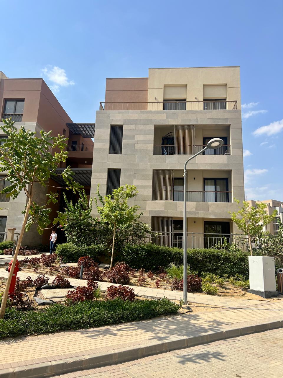 عمارة سكنية ببلكونات خلف زراعات منسقة وممشى - شقة في ديستركت 5، التجمع الخامس