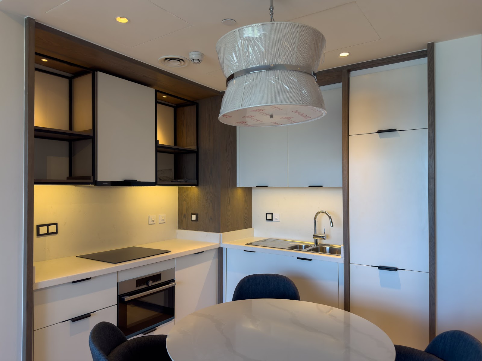 Compact kitchen with pendant lamp and round table - hotel apartment in Marassi The Address Beach, North Coast