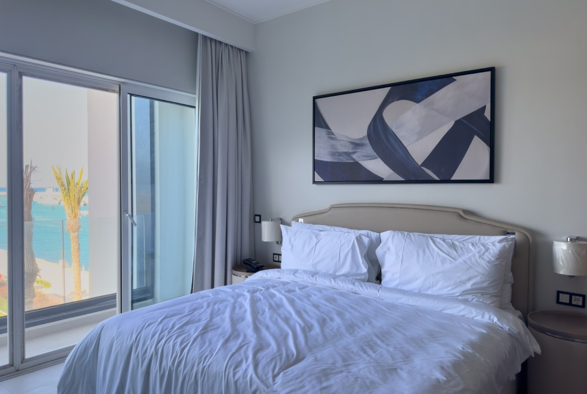 Bedroom with sea view through glass doors - hotel apartment in Marassi The Address Beach, North Coast