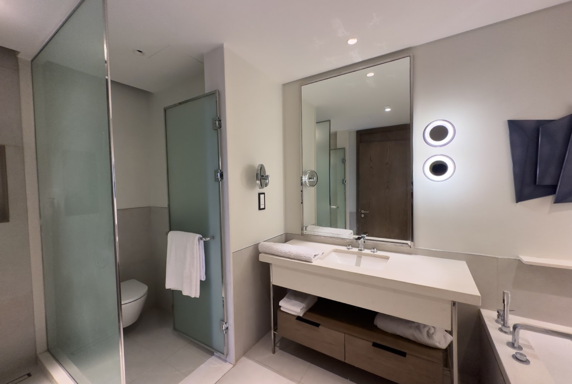 Bathroom with wide vanity, mirror and glass shower - hotel apartment in Marassi The Address Beach, North Coast