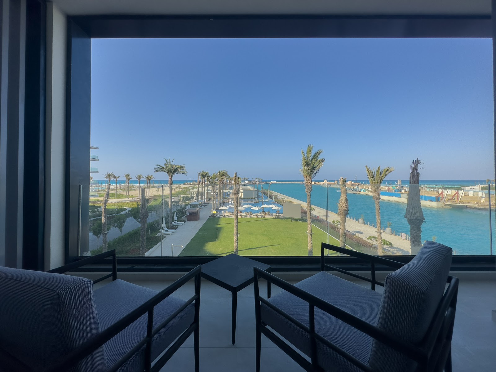 Balcony chairs facing the marina and green lawn - hotel apartment in Marassi The Address Beach, North Coast