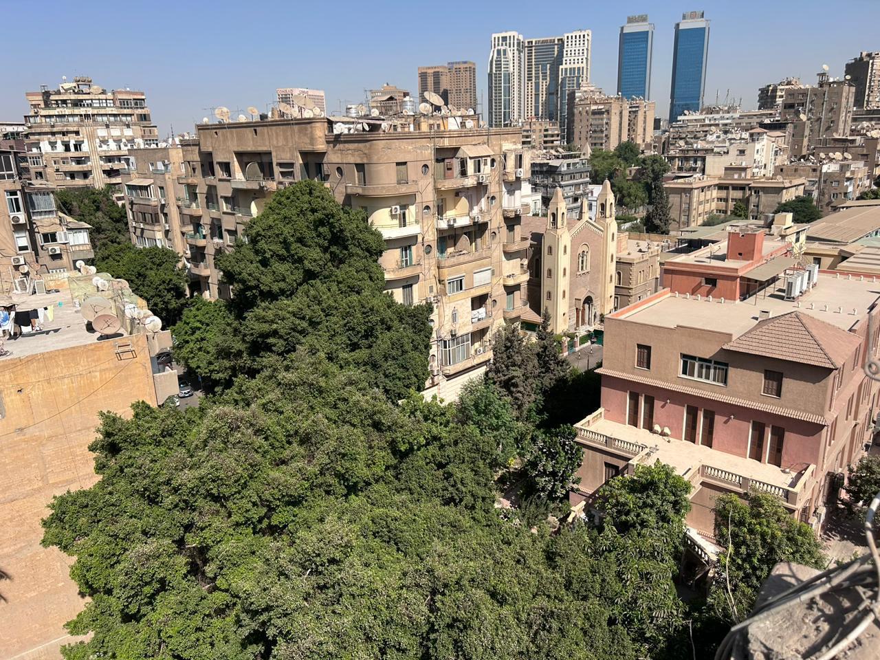 Dense city rooftops with distant towers - shop in Zamalek