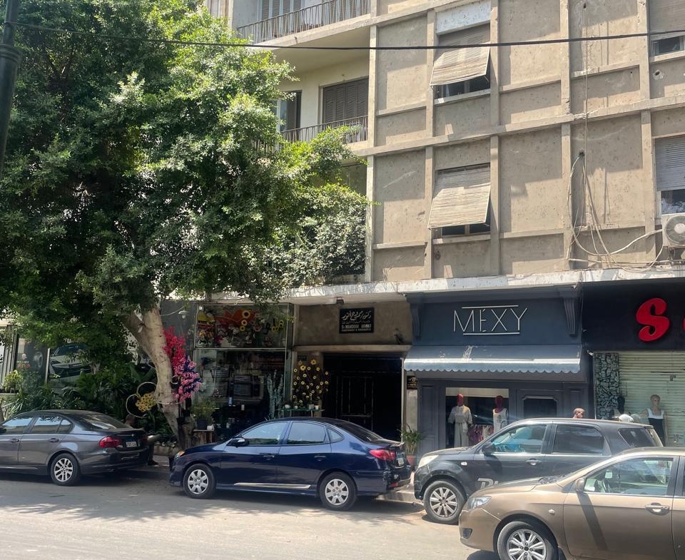 Building facade with parked cars - shop in Zamalek