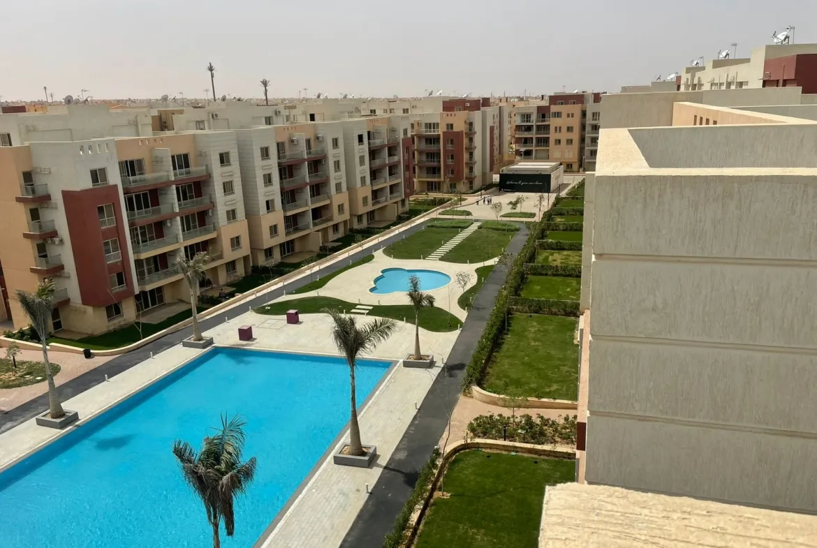 Long pool and lawns between apartment blocks seen from above - penthouse in Promenade, New Cairo