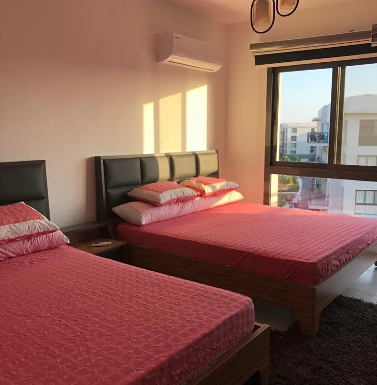 Bedroom with two red beds and pendant lamps - chalet in Marassi Marina 2, North Coast