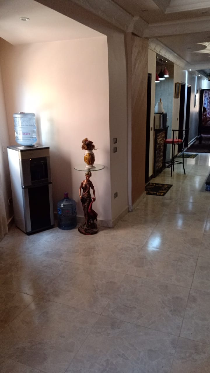 Hall with a marble floor and a vase beside a doorway - duplex in South of Academy, New Cairo