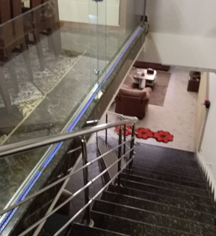Staircase with a black marble step and a steel railing - duplex in South of Academy, New Cairo