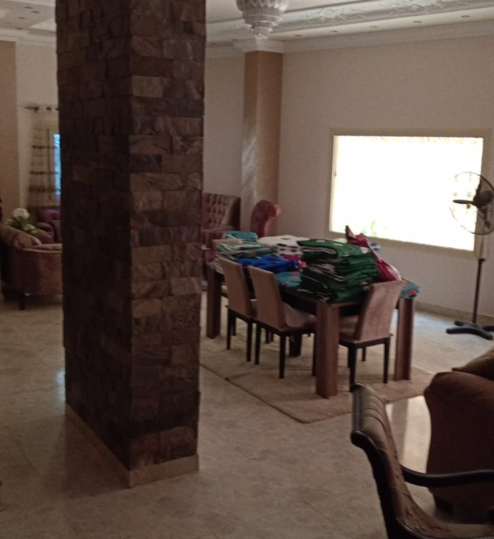 Dining area behind a stone-clad column - duplex in South of Academy, New Cairo