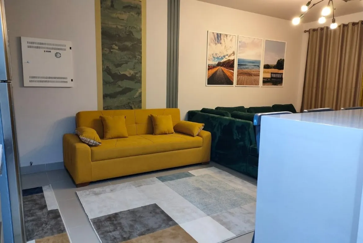 Mustard sofa and green velvet sofa with artwork on the wall - chalet in Marassi Marina 1, North Coast