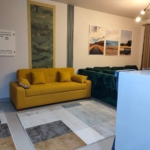 Mustard sofa and green velvet sofa with artwork on the wall - chalet in Marassi Marina 1, North Coast