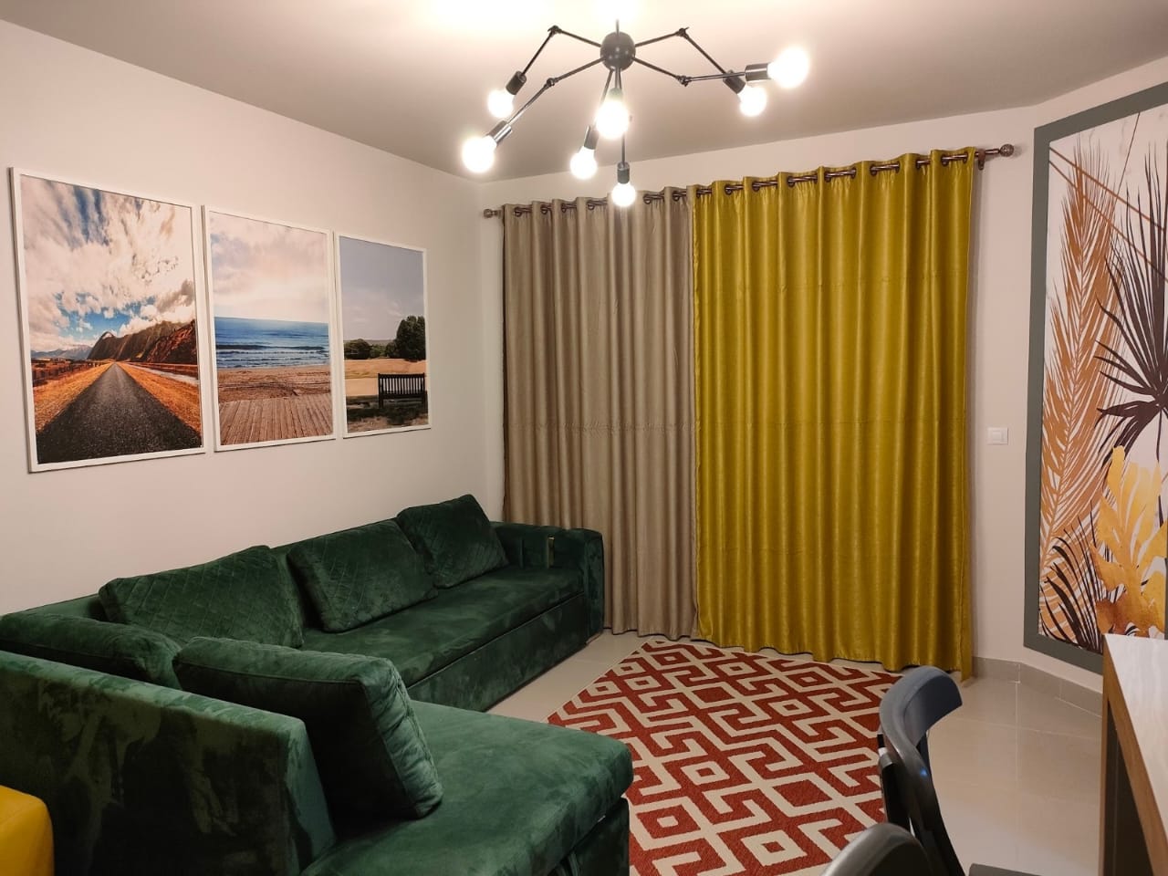 property-image-69f0a8e392a5f Green sofa and mustard curtain in the living room - chalet in Marassi Marina 1, North Coast