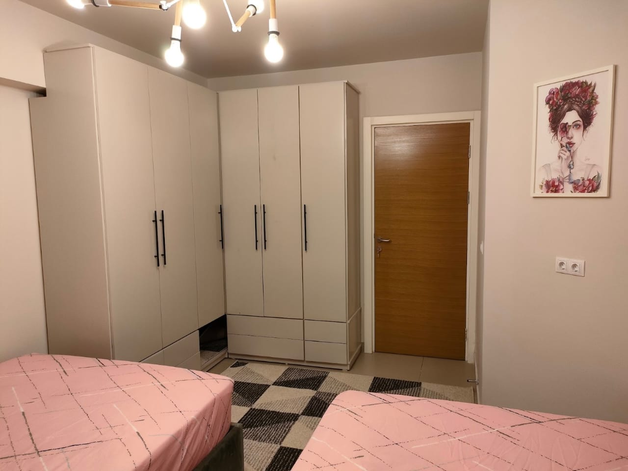 property-image-69f0a8e8b368a Pink beds in front of the wardrobe and wooden door - chalet in Marassi Marina 1, North Coast