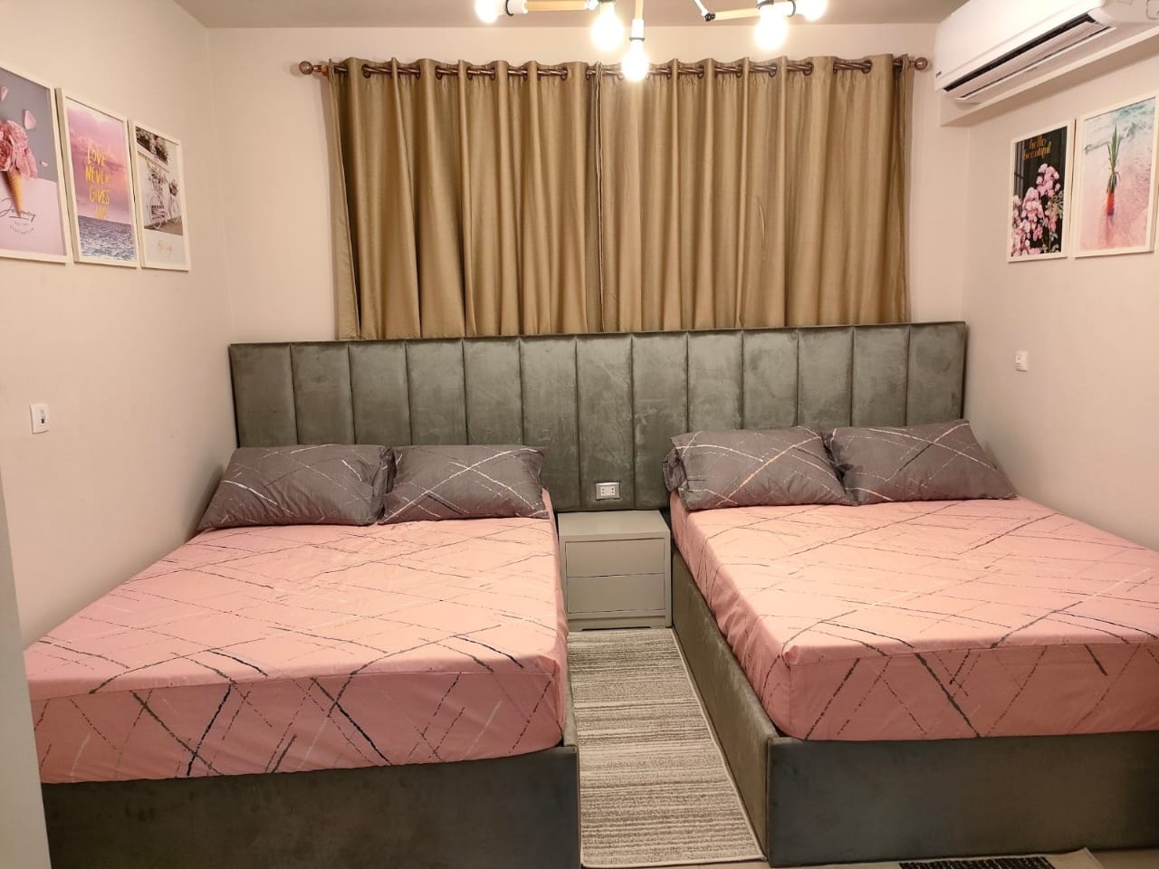 property-image-69f0a8ecc1092 Twin pink beds with grey padded headboard - chalet in Marassi Marina 1, North Coast