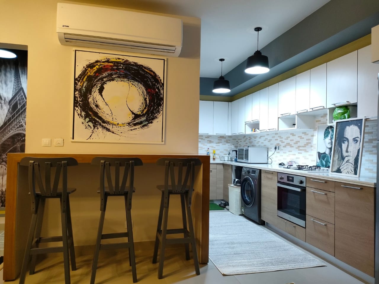 property-image-69f0a8f06e2f1 Open kitchen with wooden breakfast bar and black stools - chalet in Marassi Marina 1, North Coast