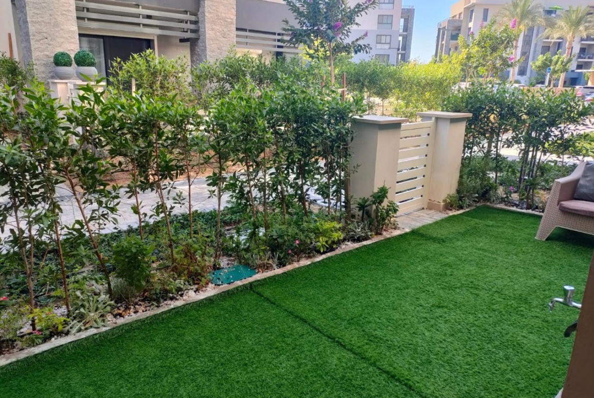 Garden terrace with green lawn and flower beds - chalet in Marassi Marina 1, North Coast