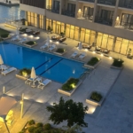 Pool and buildings lit at night beside a Marassi chalet, North Coast