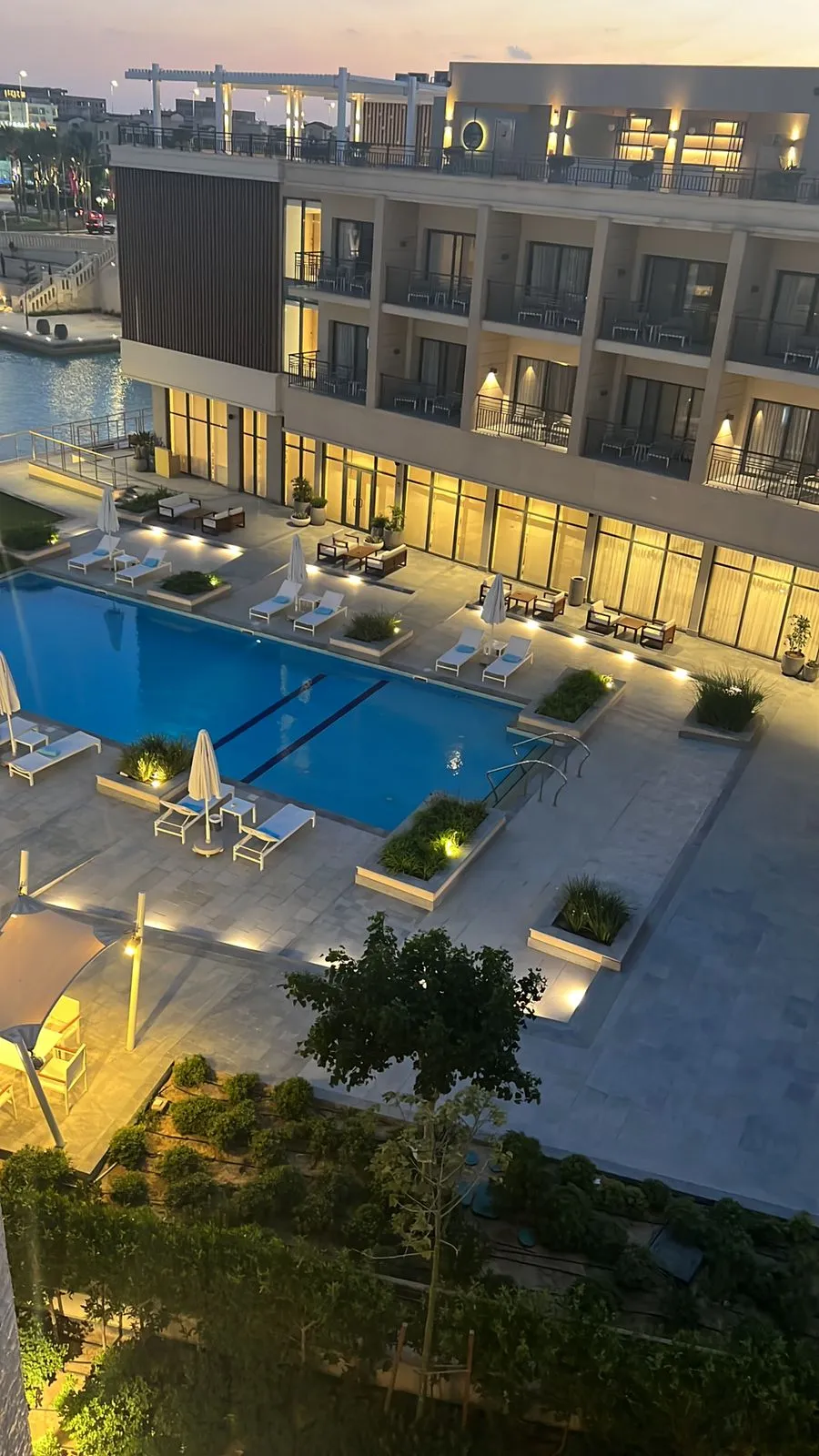 property-image-69f0ac9fa329f Pool and illuminated building from above at dusk - chalet in Marassi Marina Residence, North Coast