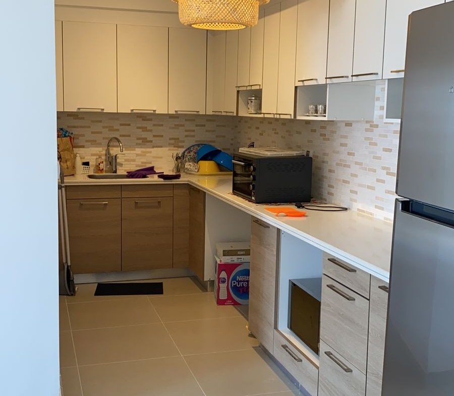 Narrow kitchen with pendant lamp and fridge - chalet in Marassi Marina Residence, North Coast