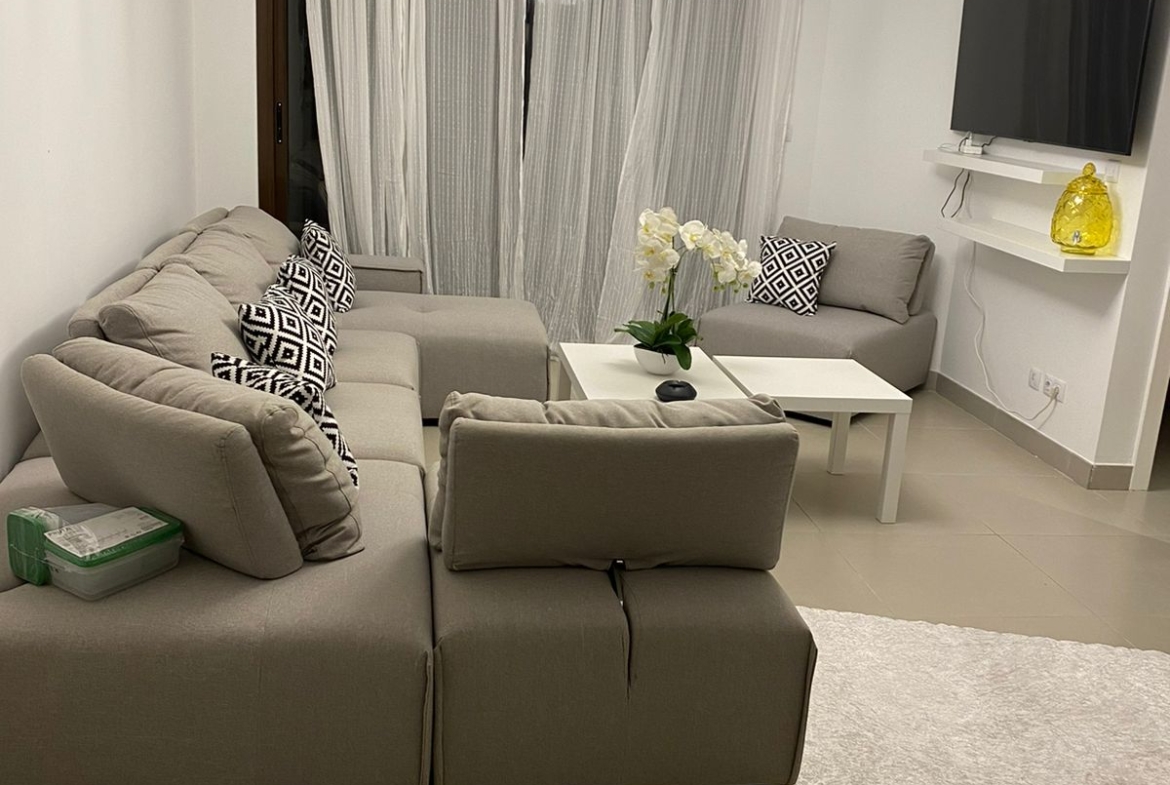 Living room with grey corner sofa and pendant globe lamp - chalet in Marassi Marina Residence, North Coast