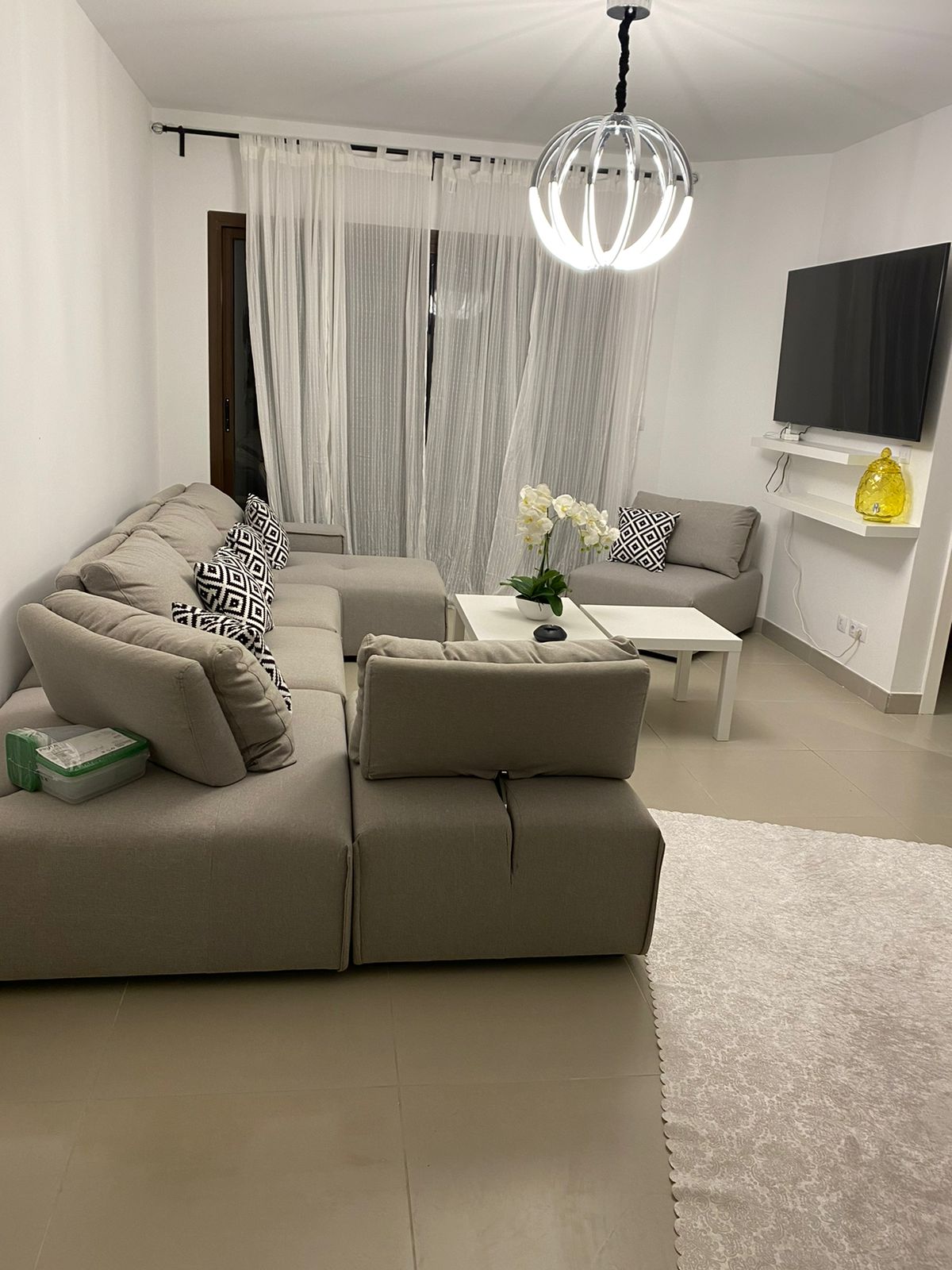 property-image-69f0aca571ec0 Living room with grey corner sofa and pendant globe lamp - chalet in Marassi Marina Residence, North Coast