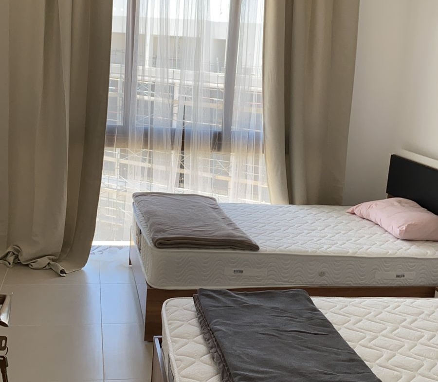 Two beds with grey blankets beside the window - chalet in Marassi Marina Residence, North Coast