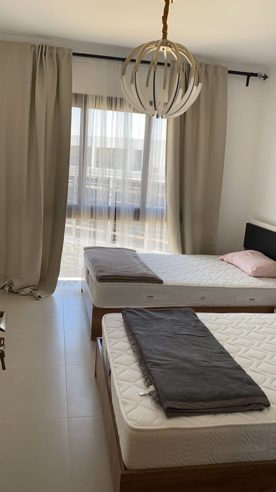 property-image-69f0aca6e44ff Two beds with grey blankets beside the window - chalet in Marassi Marina Residence, North Coast