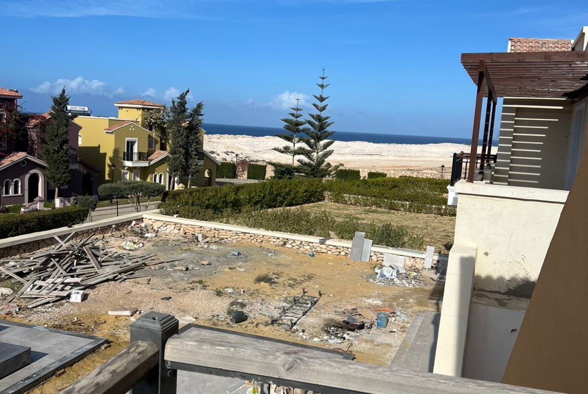 Balcony railing overlooking a construction plot and the sea - villa in Diplomats, North Coast