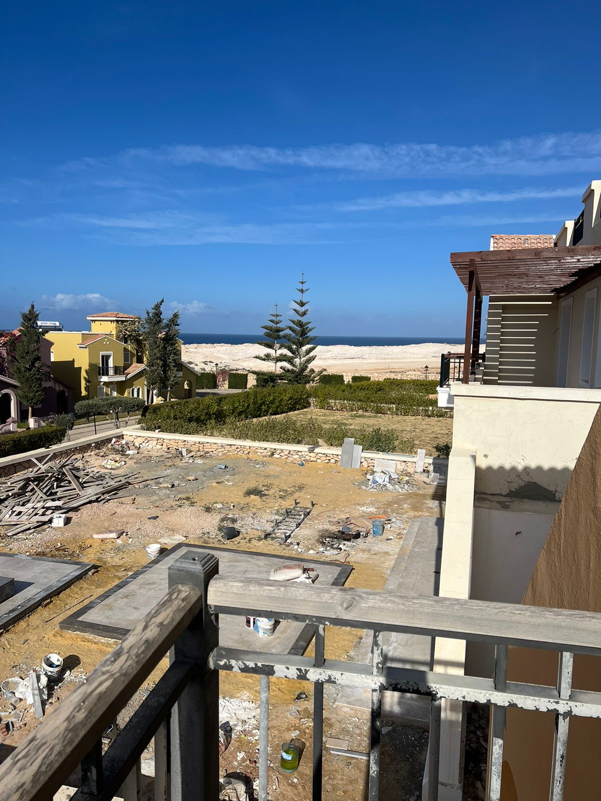 View of the sea past the balcony and building site - villa in Diplomats, North Coast