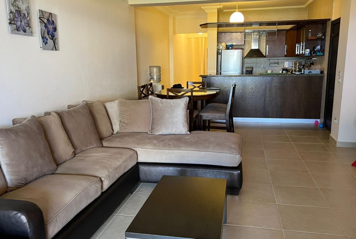 Corner sofa in a living room with an open kitchen behind - chalet in La Vista Bay, North Coast