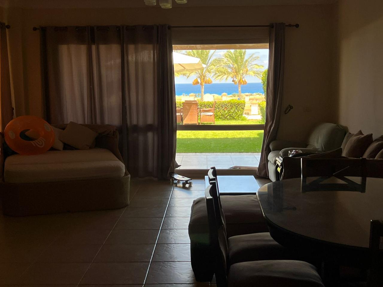 Living room doors opening to a garden with sea view - chalet in La Vista Bay, North Coast