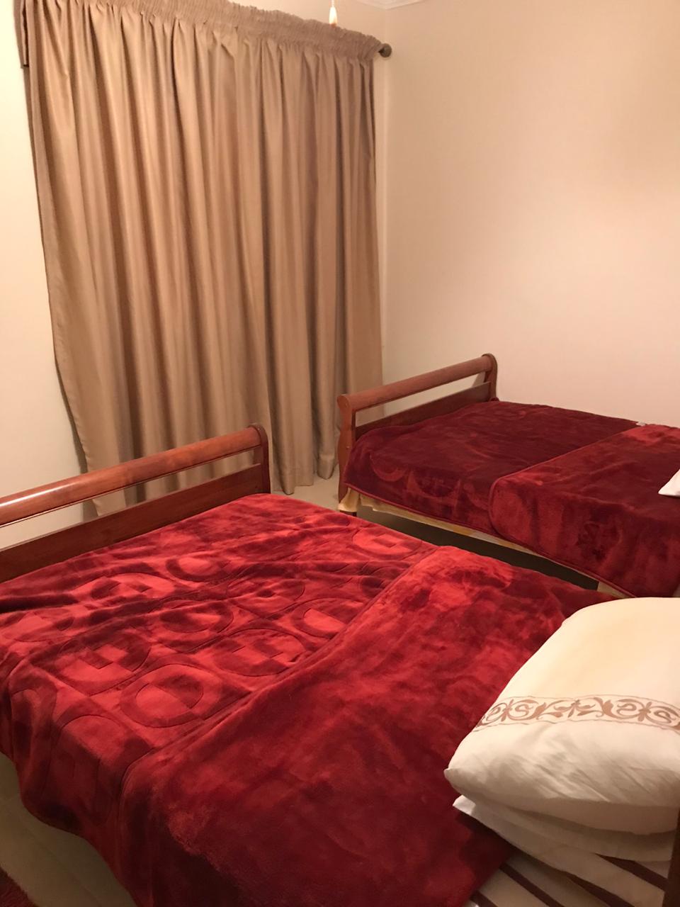 property-image-69f0c50b1ee78 Bedroom with two beds and red covers - twinhouse in La Vista 4, Ain Sokhna