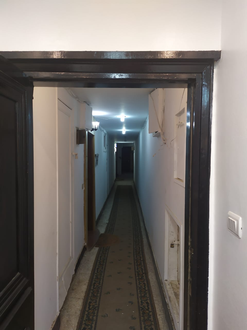 Long narrow hallway with dark floor - apartment in Zamalek
