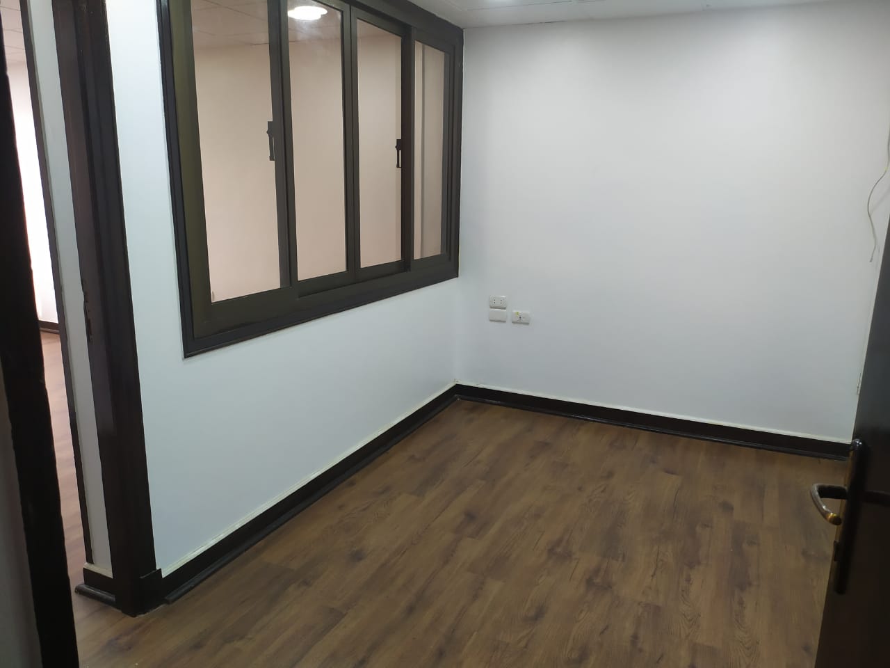 Empty corner room with a wide window - apartment in Zamalek