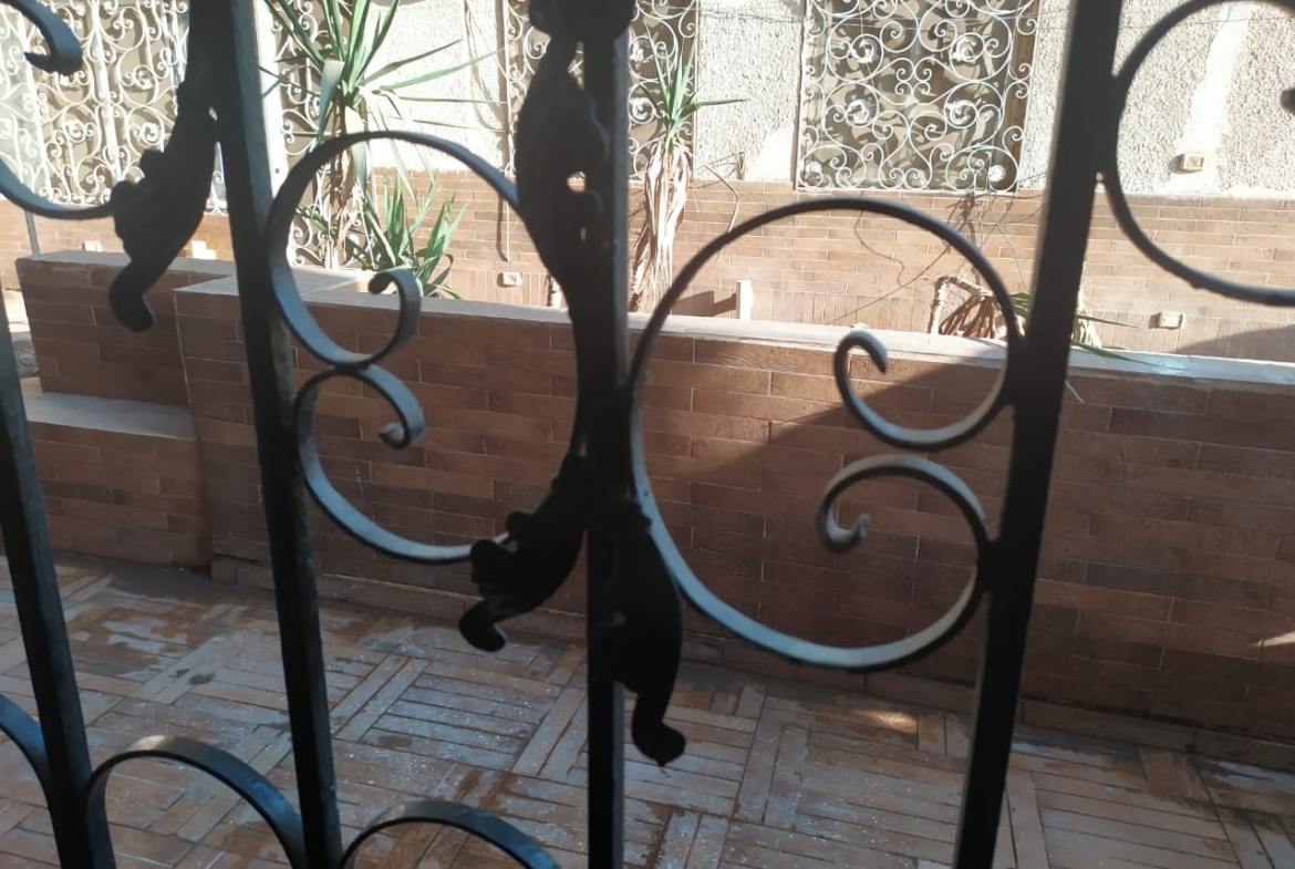 Decorative iron grille over a brick wall - apartment in Zamalek