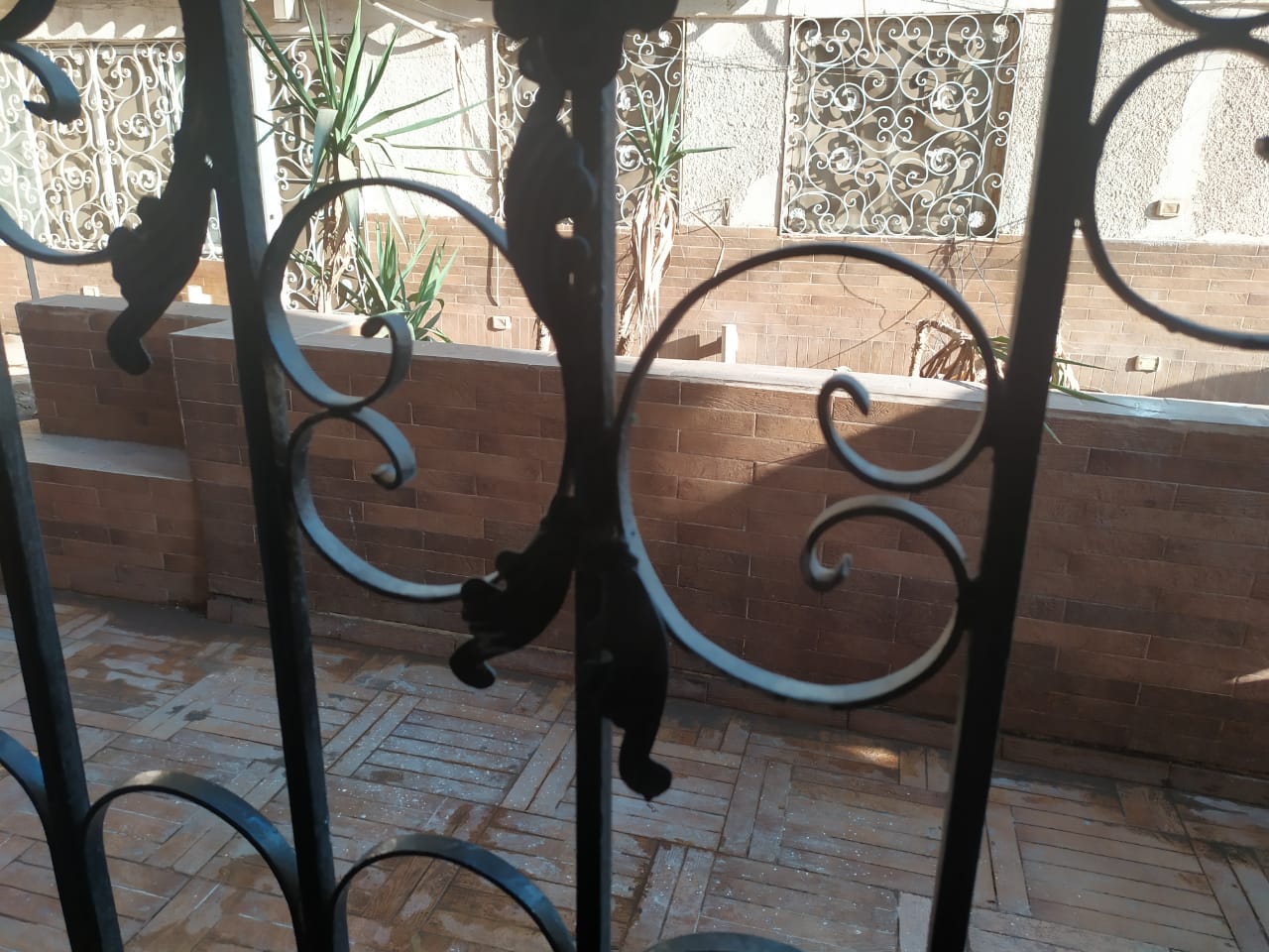 Decorative iron grille over a brick wall - apartment in Zamalek