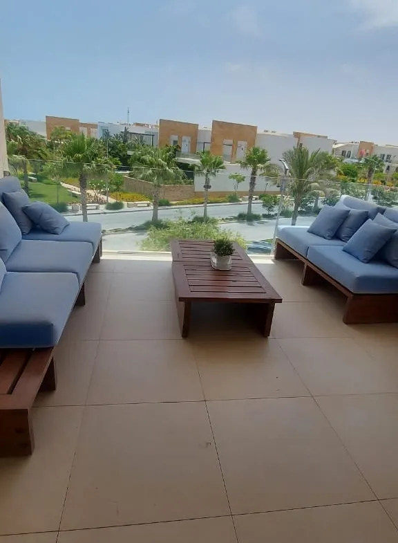 Balcony sofas and a low table with a view of the lagoon - duplex in Seashell, North Coast