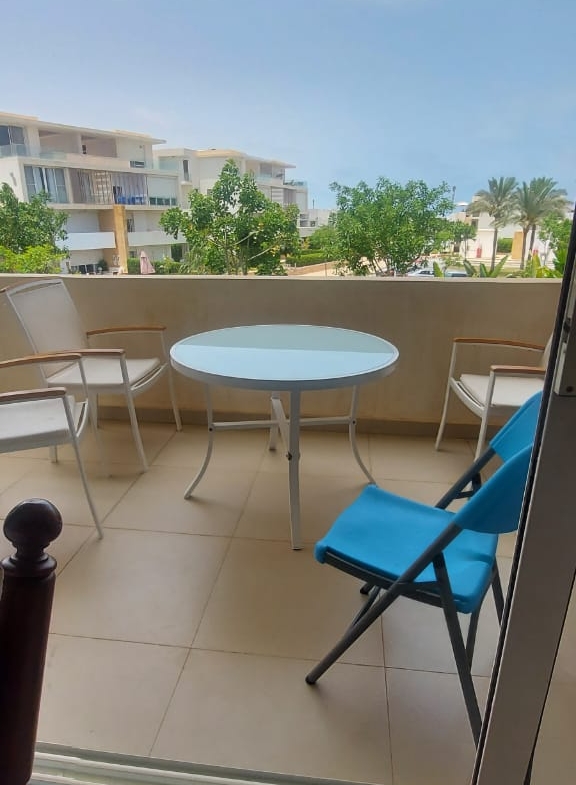 Balcony with a round table and blue chair - duplex in Seashell, North Coast