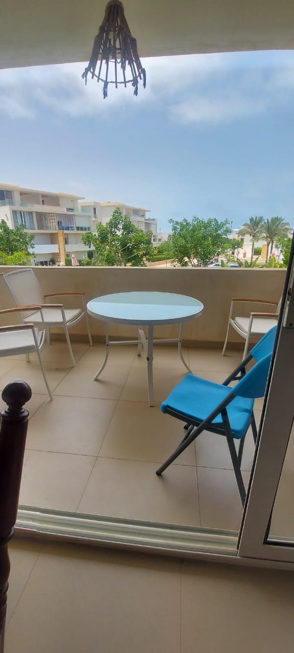 property-image-69f0d8b10bcfe Balcony with a round table and blue chair - duplex in Seashell, North Coast