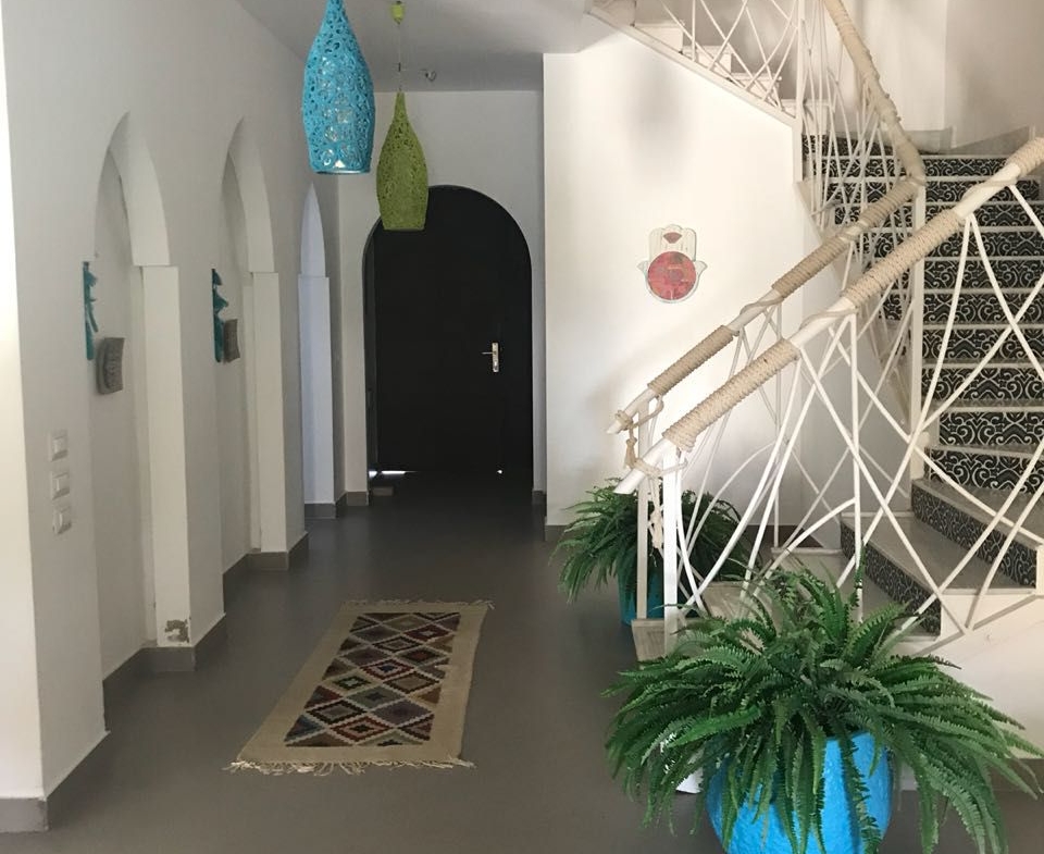 Entrance hall with arched doorway and a spiral staircase - townhouse in Hacienda Bay, North Coast