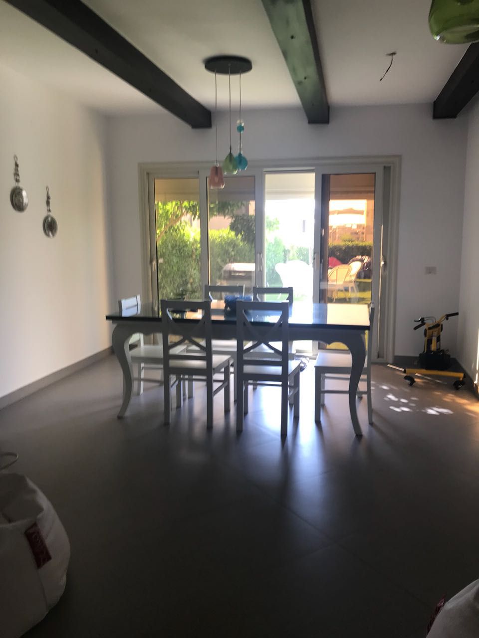 Dining table with dark chairs and a terrace door - townhouse in Hacienda Bay, North Coast